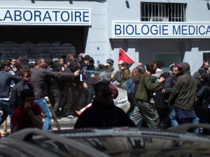 Security members of French workers' union CGT spray pepper spray as they clash with other protesters on May 12, 2016 in Marseille, southeastern France, during a demonstration after the French government made use of the constitution's Article 49,3, allowing them to bypass parliament to force through a controversial labour reform bill. France's embattled Socialist government faces a no-confidence vote May 12 after bypassing parliament to force through a labour reform bill that has drawn hundreds of thousands onto the streets over the last two months. / AFP PHOTO / BERTRAND LANGLOIS